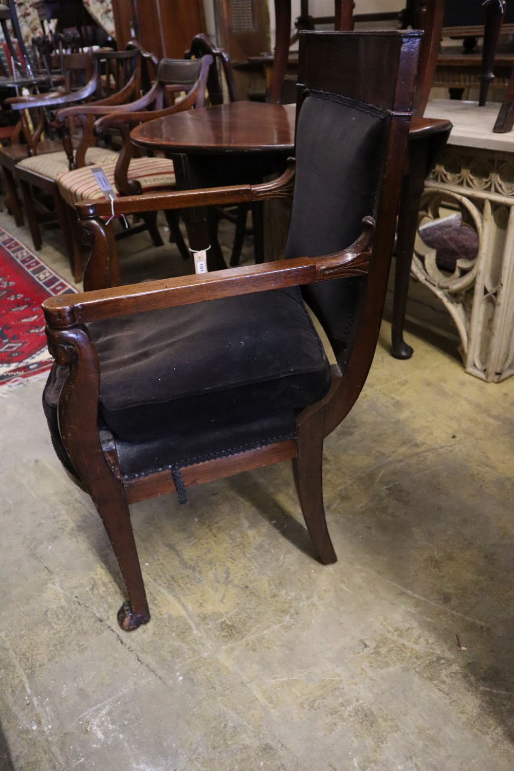 A French Empire mahogany fauteuil with lions paw feet